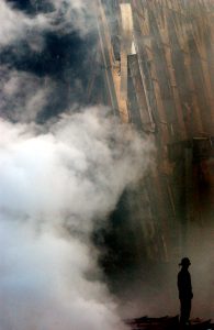 010914-N-1350W-004 New York, N.Y. (Sept. 14, 2001) -- A solitary fire fighter stands amidst the rubble and smoke in New York City. Days after a Sep. 11 terrorist attack, fires still burn at the site of the World Trade Center. U.S. Navy Photo by Photographer's Mate 2nd Class Jim Watson. (RELEASED)